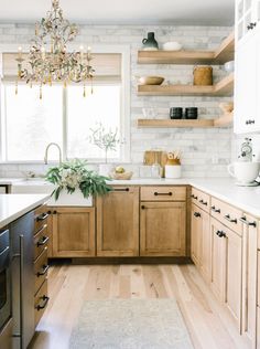 a kitchen with wooden cabinets and white counter tops, along with an area rug on the floor