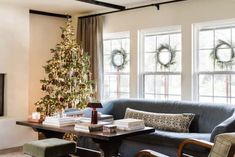 a living room filled with furniture and a christmas tree