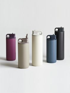 thermos are lined up in different colors