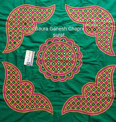 a green cloth with red and yellow designs on it