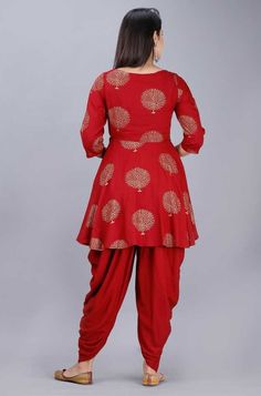 Handcrafted with absolute perfection, this Kurti with Dhoti pants set is perfect for small festive occasions. The fabric used is rayon and is very soft and comfortable to wear all day long. The Kurti has a peplum style with foil print all over. Fabric: Rayon Sizes: Garment measurement: Bust (in inches): S(36), M(38), L(40), XL(42), 2XL(44), 3XL(46), 4XL(48), 5XL(50) Choose garment measurement 2 inches more than your body bust measurement Print: Foil Print Wash care: Dry Clean Dispatch within 7 d Traditional Rayon Sets For Eid, Traditional Festive Rayon Sets, Traditional Harem Pants With Festive Drape, Festive Rayon Sets For Eid, Festive Traditional Harem Sets, Traditional Rayon Kurta For Festivals, Festive Rayon Kurta, Traditional Rayon Sets For Festivals, Bollywood Harem Salwar Kameez For Diwali