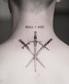 a man's back neck with three crossed swords and the words still i rise on it