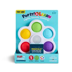 a set of four different colored play doughs in a cardboard box with the words pop it and learn