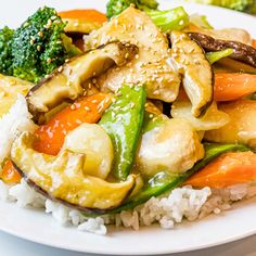 a white plate topped with rice and veggies