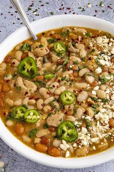 a white bowl filled with bean and vegetable soup