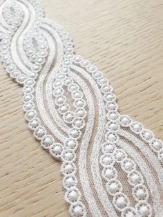 an image of white lace on wood table