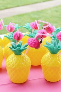 small pineapples with flamingos on them sitting on a table