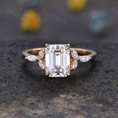 an emerald cut diamond ring with three side stones