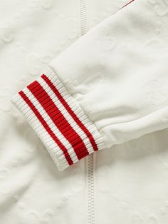 Creative Director Alessandro Michele often references retro athletics styles in Gucci's clothing. This hooded bomber jacket is jacquard-knitted with the house's logo and traced along the sleeves with signature striped webbing. It'll offset relaxed tailoring nicely. White Track Jacket With Ribbed Collar For Winter, Casual Gucci Outerwear With Drawstring Hood, Gucci Winter Outerwear With Drawstring Hood, Gucci Hooded Outerwear With Drawstring, Gucci Outerwear With Drawstring Hood For Fall, Gucci Long Sleeve Outerwear With Drawstring Hood, Sporty White Outerwear With Ribbed Collar, Gucci Sporty Hoodie With Drawstring Hood, Gucci Hoodie With Drawstring For Streetwear