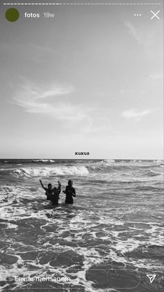 black and white photograph of people in the ocean