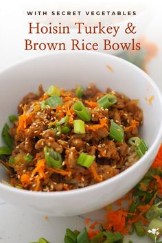 a white bowl filled with brown rice and vegetables