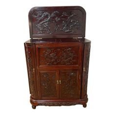 an ornate wooden cabinet with carvings on it