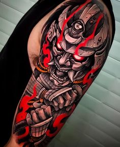 a man with a tattoo on his arm holding a wrench and wearing a helmet