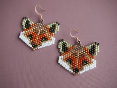 a pair of fox earrings with beaded details