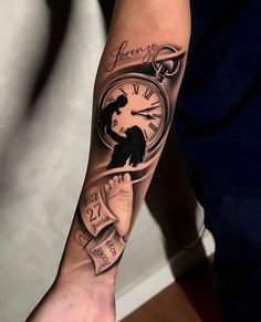 a person with a tattoo on their arm holding a clock and ribbon around the wrist