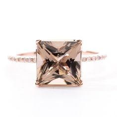 an engagement ring with a square cut morganite in rose gold and white diamonds on the band