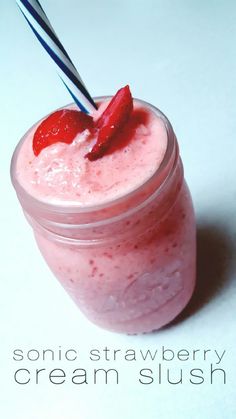 a strawberry cream slush in a glass jar with a straw sticking out of it