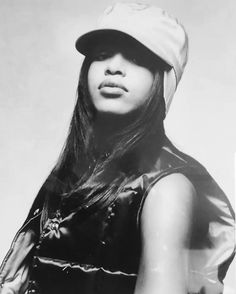 a black and white photo of a woman wearing a hat