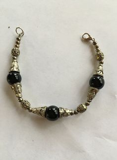 Black Onyx Bead Bracelet 3 Onyx Beads surrounded by Silver Tone Worked Beads  No Makers Mark Lobster Claw Catch Condition - Good Enjoy Vintage Light Switches, Onyx Bead, Gold Hoop, Gold Hoop Earrings, 10k Gold, Bead Bracelet, Makers Mark, Black Onyx, Pandora Charm Bracelet