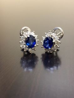 DeKara Designs Collection Metal- 90% Platinum, 10% Iridium. Stones- 2 Oval Shaped Ceylon Blue Sapphires 1.20 Carat each, 24 Round Diamonds G Color VS2 Clarity, 1.05 Carats. Beautiful Art Deco Inspired Handmade Platinum Ceylon Blue Sapphire Diamond Halo Earrings. The entire earrings are hand assembled, the back of the earrings are made in 90% platinum. The sapphires are sitting in between 4 prongs, and the diamonds are surrounding them and prong set as well. The sapphires are perfectly matching i Classic Clip-on Cluster Earrings For Formal Occasions, Classic Clip-on Cluster Earrings For Formal Events, Gia Certified Sapphire Diamond Earrings For Formal Occasions, Elegant Blue Gia Certified Diamond Earrings, Formal Gia Certified Sapphire Diamond Earrings, Gia Certified Cluster Earrings For Formal Occasions, Luxury Oval Sapphire Earrings, Gia Certified Sapphire Earrings For Formal Occasions, Luxury Oval Gia Certified Earrings