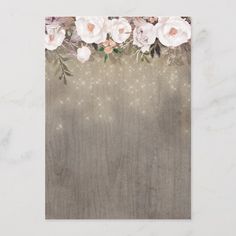 a card with flowers and sparkles on the bottom, in front of a marble background