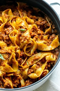 a pot filled with pasta and meat sauce