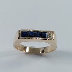 This Handmade Sapphire and Diamond Ring has been carefully crafted in 10k Yellow Gold, Authentic White Diamonds  and Authentic Sapphire. This delicate ring would make an amazing birthday/any occasion gift. Ring will be shipped to you in an elegant gift box and it can resized at no extra cost. Once the ring has been mailed a tracking shipping number will be provided to you. Sapphire Measurements: 4 Sapphire: 2.5 mm x 2.5 mm Diamond Measurements: 2 Diamonds, each stone is 1.5 mm, 0.015 cts, total 14k Gold Rings With Princess Cut And Accent Stones, 14k Gold Princess Cut Rings With Accent Stones, Blue 14k Gold Signet Ring Fine Jewelry, 14k Gold Blue Three Stone Jewelry, Blue Signet Ring With Birthstone For Anniversary, Heirloom Blue Three-stone Ring, Sapphire Three Stone Ring In 14k Gold, Formal Three Stone Sapphire Ring In 14k Gold, Formal Three-stone Sapphire Ring In 14k Gold