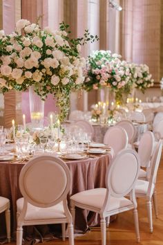 an image of a table setting with flowers and candles in the center for a wedding reception