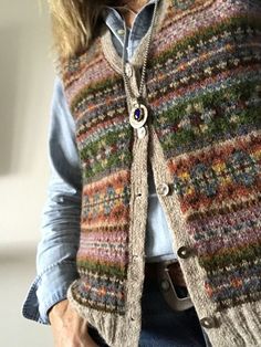 a woman wearing a multicolored vest with buttons on the front and back side