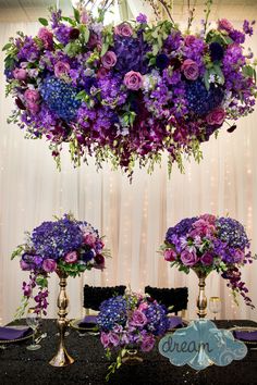 purple flowers and greenery decorate the centerpieces for a wedding reception at dreams