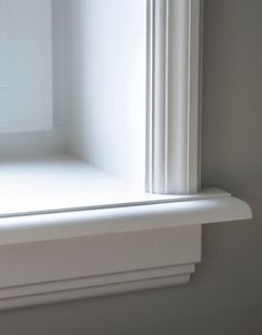 an open window with white trim in a room