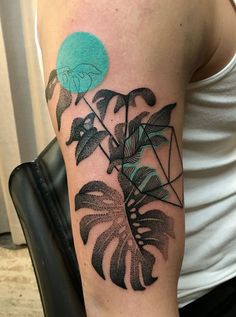 a man with a tattoo on his arm next to an image of a monster plant