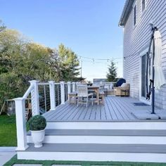 a deck with chairs and an umbrella on it