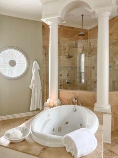 a large white bath tub sitting under a window