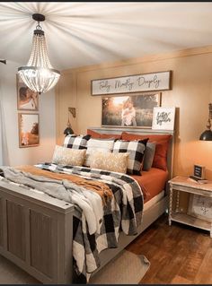 a bedroom with a bed, nightstands and pictures hanging on the wall above it