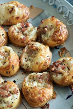 small pastries with meat and cheese on a plate