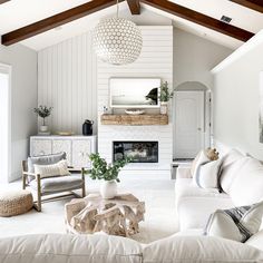 a living room filled with furniture and a fire place in the middle of the room