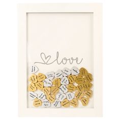 a white frame filled with lots of yellow and white heart shaped conversation hearts that spell out the word love