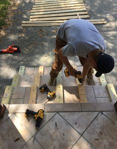 a man working on some wood with tools