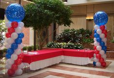 an entrance decorated with balloons and red, white, and blue decorations for a party