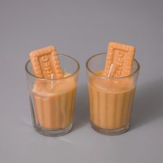 two glasses filled with peanut butter cookies on top of each other