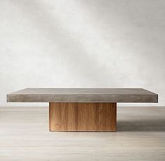 a concrete and wood table in an empty room