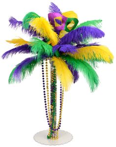 there is a palm tree decorated with beads and feathers on the top, as well as beads