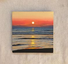 a painting of the sun setting over the ocean