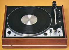 an old record player sitting on top of a wooden box with a microphone in it