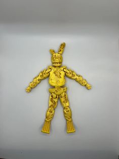 a yellow plastic toy with an animal on it's chest