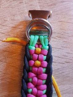 a keychain made out of beads on top of a wooden table