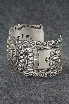 This stunning and intricate sterling silver bracelet was made by Navajo silversmith Eugene Charley. The inside is signed and stamped sterling.Size: 6" (will fit up to a 7 3/8" wrist)Gap: 1 3/8"Width: 1 1/2"Free shipping on all orders! We ship with USPS and always include tracking. All orders ship within a day of payment.Returns are accepted up to 30 days after you receive your order. Just send us a message. Our shop offers cash back or store credit. The item must be returned in new condition. Southwestern Engraved Jewelry For Festivals, Unique Antique Silver Bracelet With Oxidized Finish, Unique Antique Silver Bracelets With Oxidized Finish, Vintage Sterling Silver Jewelry For Festivals, Etched Sterling Silver Bracelet For Wedding, Southwestern Sterling Silver Jewelry For Festivals, Adjustable Sterling Silver Bracelet With Intricate Design, Bohemian Silver Jewelry Stamped 925, Bohemian Sterling Silver Cuff Bracelet