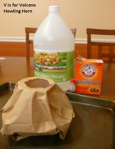 a bottle of baking soda sitting on top of a metal pan next to a brown paper bag