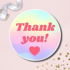 a round sticker with the words thank you in pink and gold foil on it